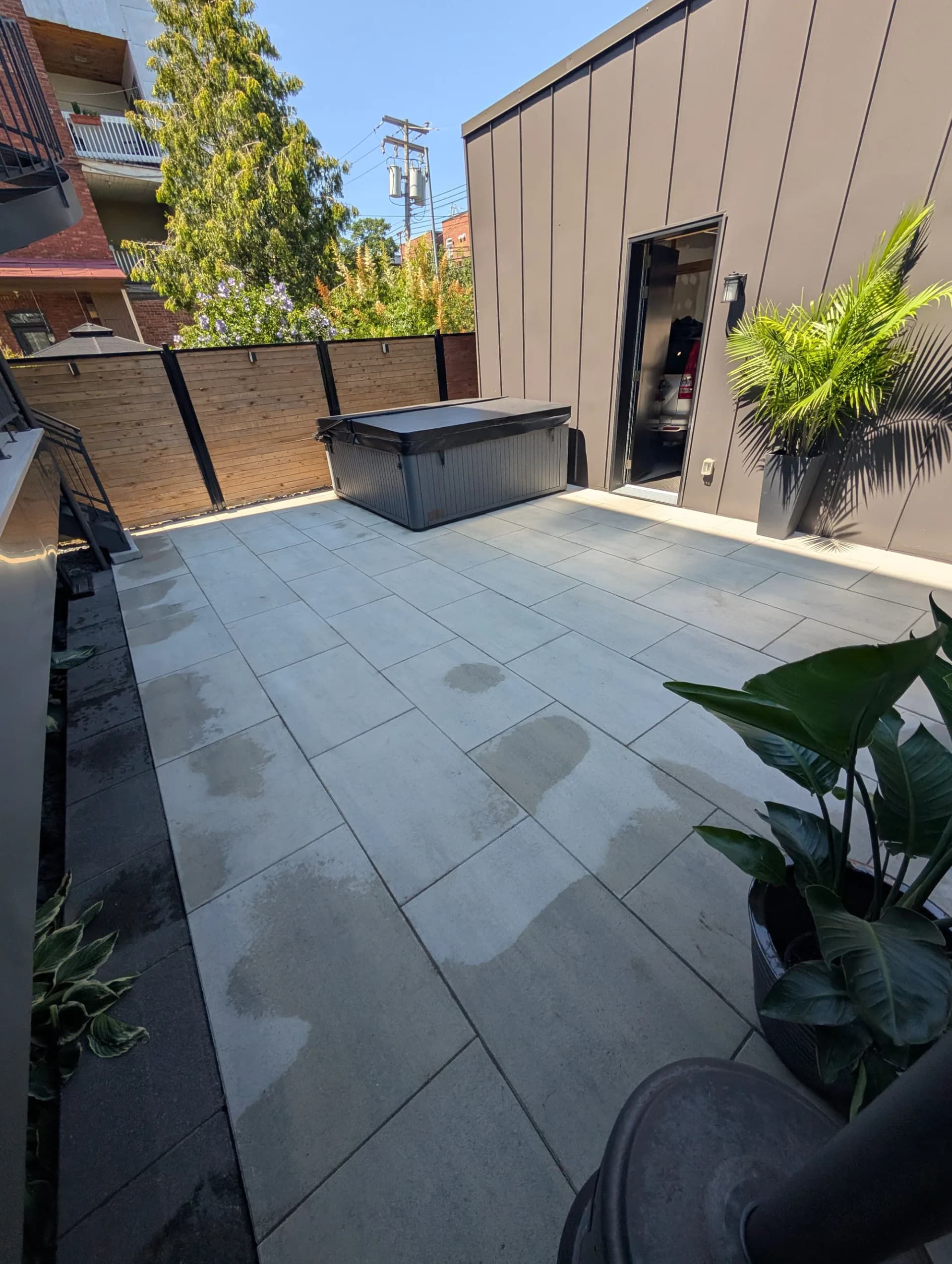Terrasse urbaine en dalles grand format avec spa et plantations, Grand Montréal